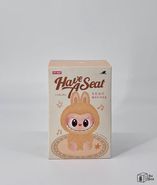 THE MONSTERS Labubu Have a Seat Vinyl Face Single Box (1 Blind Box) featuring a collectible Labubu Vinyl Face figure in a sitting pose, perfect for fans and collectors of Labubu's unique character designs.